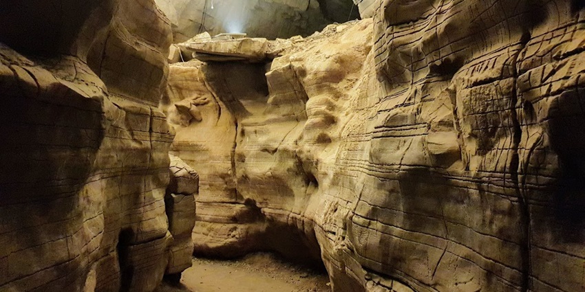 A picture of a cave section at Mawtynhiang Cave with strange walls on both sides