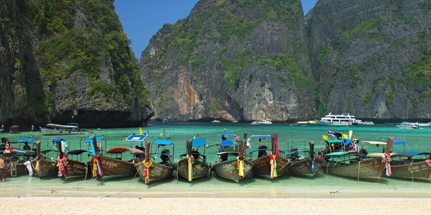 Explore the crystal-clear waters and scenic high cliffs of Maya Bay on Phi Phi Island