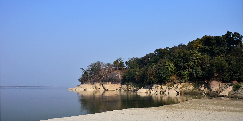 An image of a misty view of the sacred Brahmaputra river in Mayong village at dawn.
