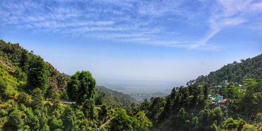 Stunning view of Bhagsu Valley in McLeod Ganj, showcasing lush greenery and mountains.