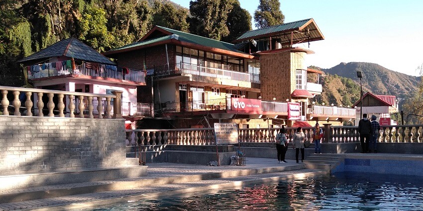A picture of a temple in Mcleodganj taken from a pool nearby