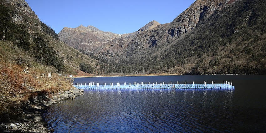 Tranquil high-altitude lake nestled amid barren slopes, with a trout hatchery nearby