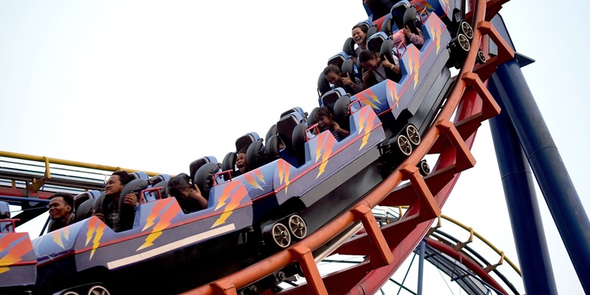 Beautiful image of the children having fun at the thrilling rollercoaster in the adventure park