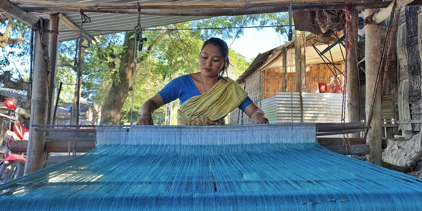 Snapshot of a Mising Tribal Woman weaving mekhela sador- Things to do in Kaziranga