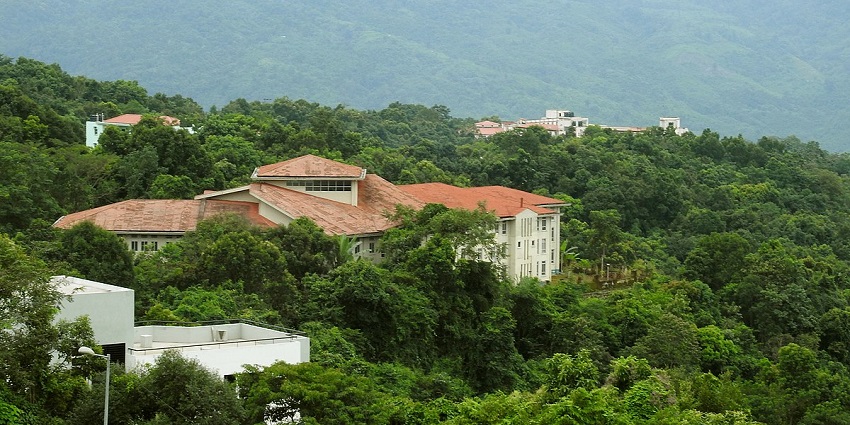 A view of the Mizoram University in Mizoram with people in front during the daytime.