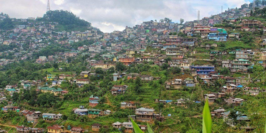 A view of colourful houses elegantly nestled in the terraced green hills of Mokokchung.