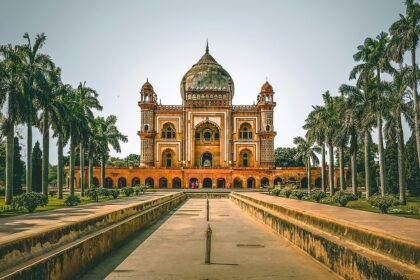 A breathtaking view of a historical monument with long lush green trees on all sides.