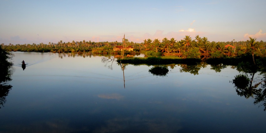 A beautiful image of a water body creating the reflection of the island
