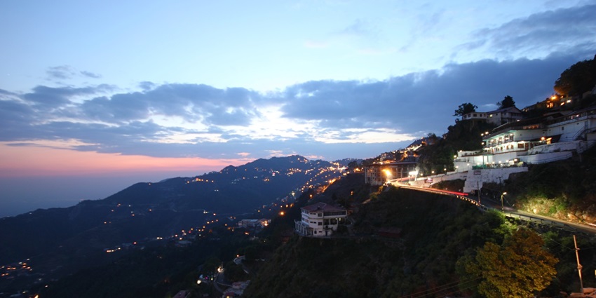 Evening view of Mussoorie with glowing lights, misty hills—places to visit near delhi in october