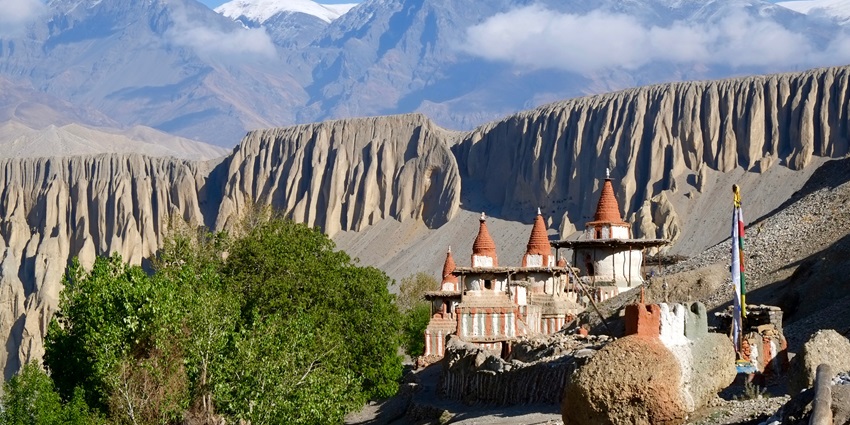 A picture of the lush mountains in Nepal with a beautiful temple visible