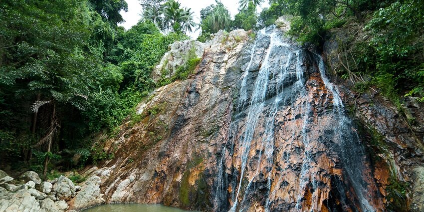 Go swimming in the cool waters of Na Muang Waterfalls when wondering what to do in Koh Samui, Thailand