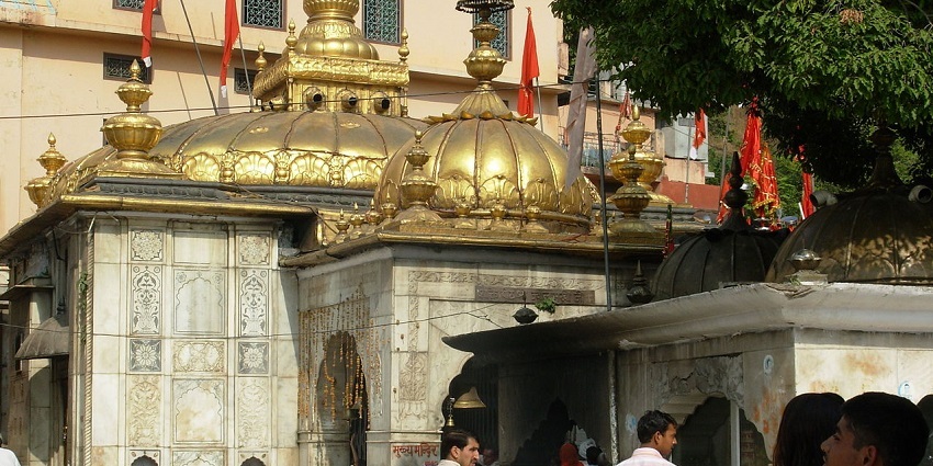Tourists wandering around the hall of the temple waiting for darshan