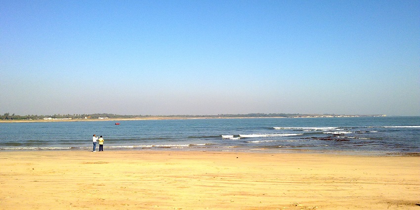 An image of two men enjoying the beautiful view of the ocean at the popular Nagoa Beach.