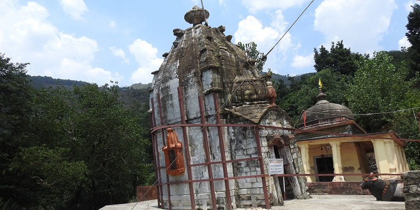 A picture of an ancient Hindu temple in Nagrota Bagwan with hills in the background