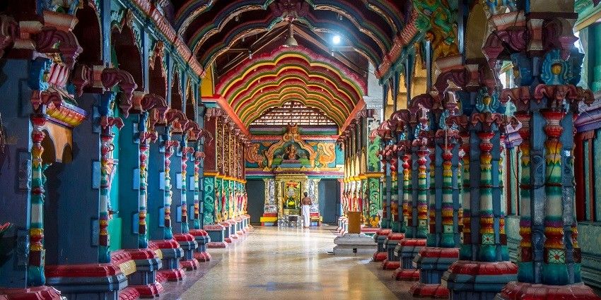 Beautifully carved corridors of a temple, reflecting rich cultural heritage and artistry.