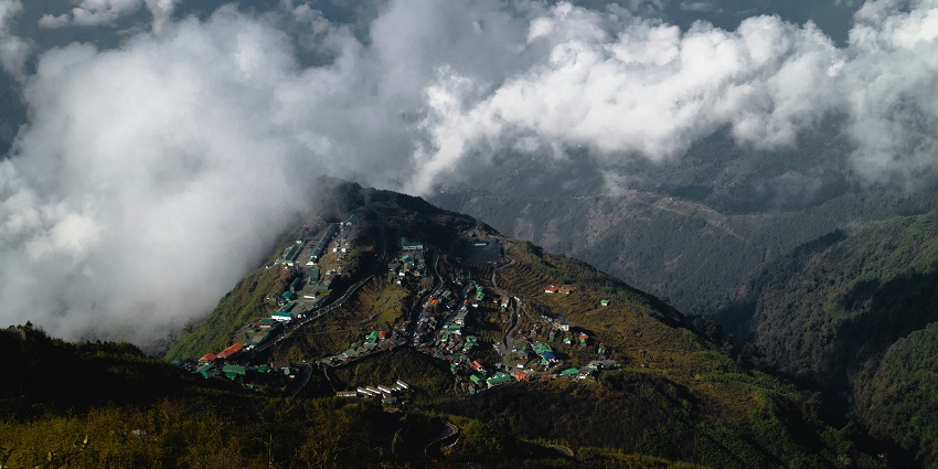 A view of small colourful houses nestled on the top of green-capped peaks in Namchi.