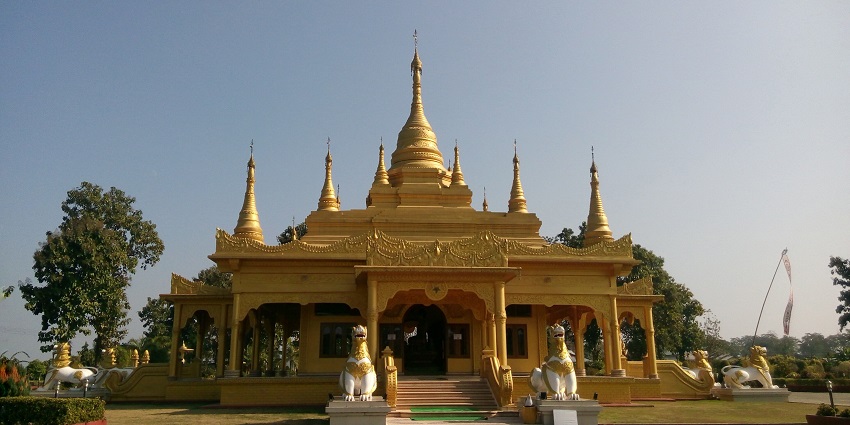 Namsai Golden Pagoda, a striking Buddhist temple, surrounded by lush greenery.