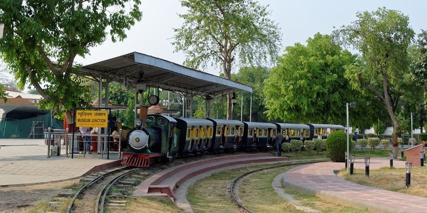 Toy train at National Rail Museum, New Delhi, with visitors enjoying the ride.