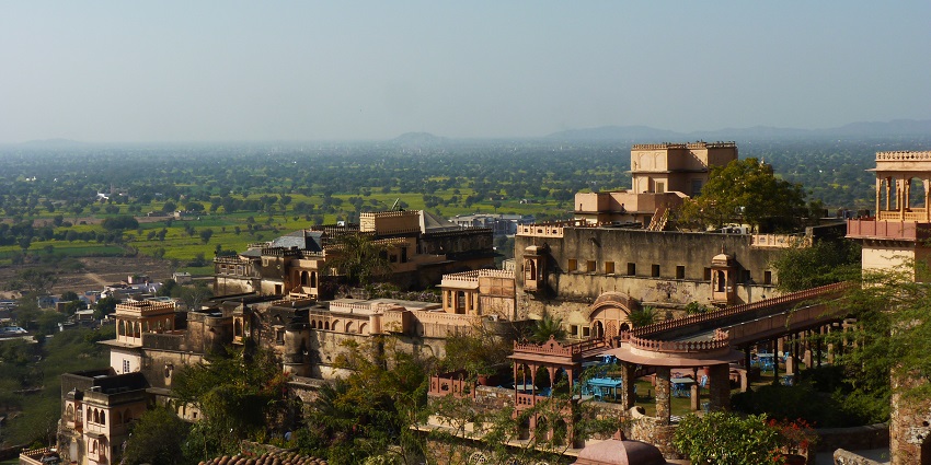 A picture of the Neemrana Fort taken from a distance showing the nearby hilly area