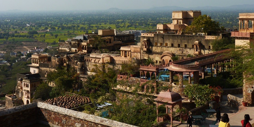 A picture of the Neemrana Fort taken from a distance showing the nearby hilly area