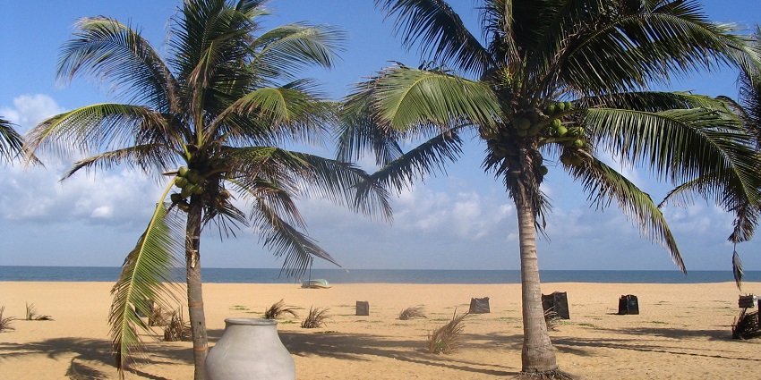 Sunset over Negombo Beaches, with calm waves and golden sands stretching along the coast.