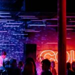 A view of radiant lights and people dancing to the beats in a bar to enjoy after hours.