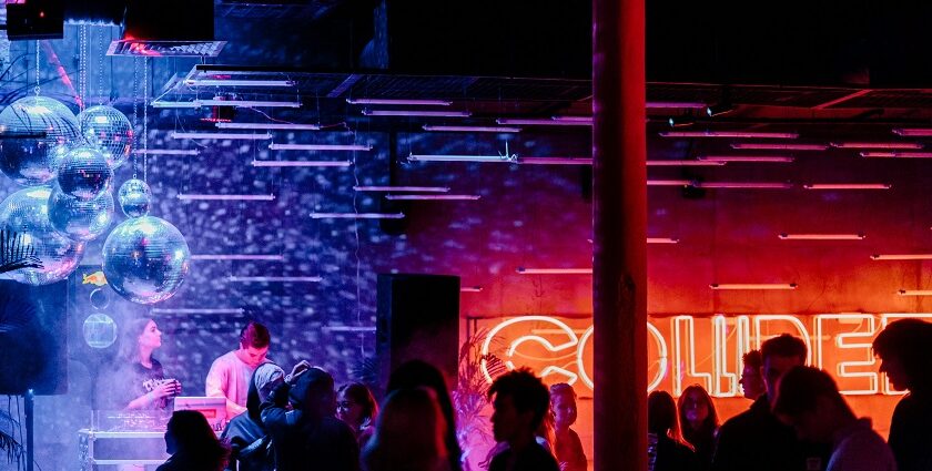 A view of radiant lights and people dancing to the beats in a bar to enjoy after hours.