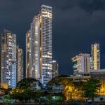 A scenic view of towering buildings with a backdrop of starry sky in the region.