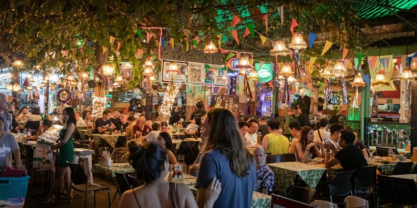 A view of people enjoying the amazing ambience at a restaurant during night time