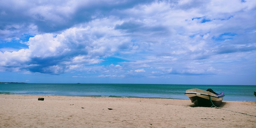 A breathtaking view of shimmering blue waters meeting the golden sands of Nilaveli.