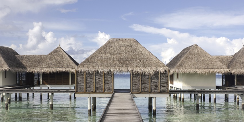 A frontal view of a waterhead villa at an island in the Maldives, with a sea in the background