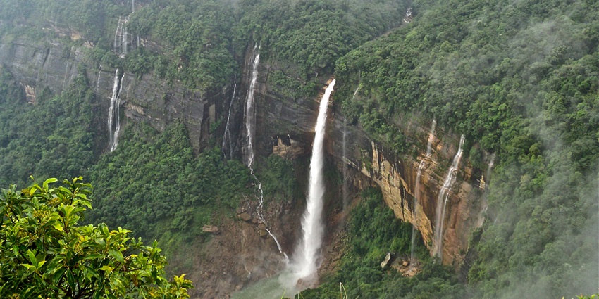 A picture of a famous waterfall with cascading water near the Garden of caves in Meghalaya