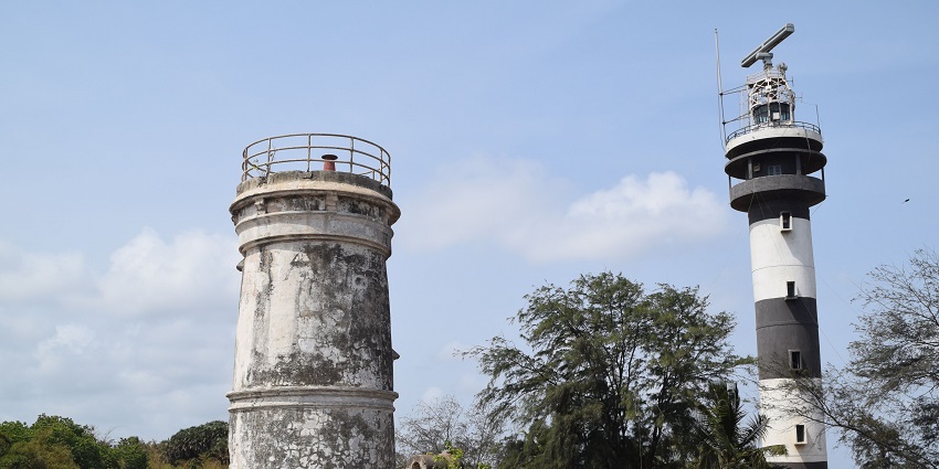 A picture of the Old Lighthouse and New Lighthouse with a backdrop of cloudy sky.