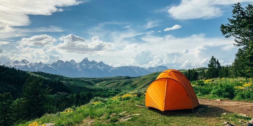 Beautiful location with an orange outdoor tent, set against a scenic landscape and clear skies.