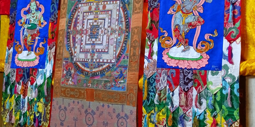 A picture of traditional Buddhist wall hangings in vibrant colours