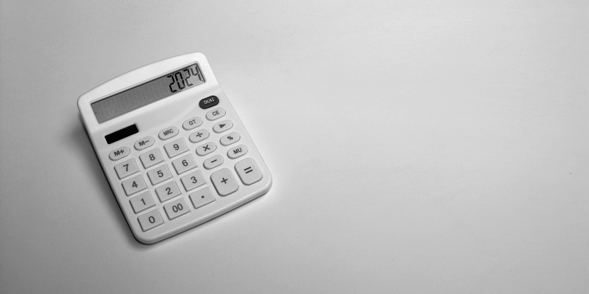 An aerial view of a white calculator sitting on top of a white surface with numbers on it.