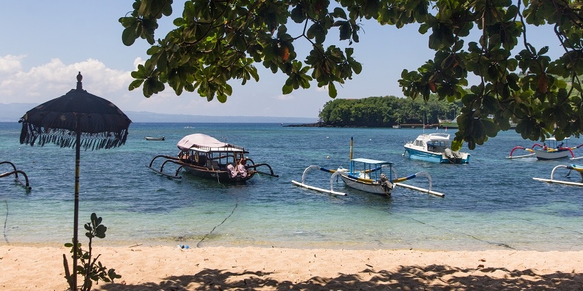 A picture taken from a beach famous for snorkelling in Bali with ferries parked in the water