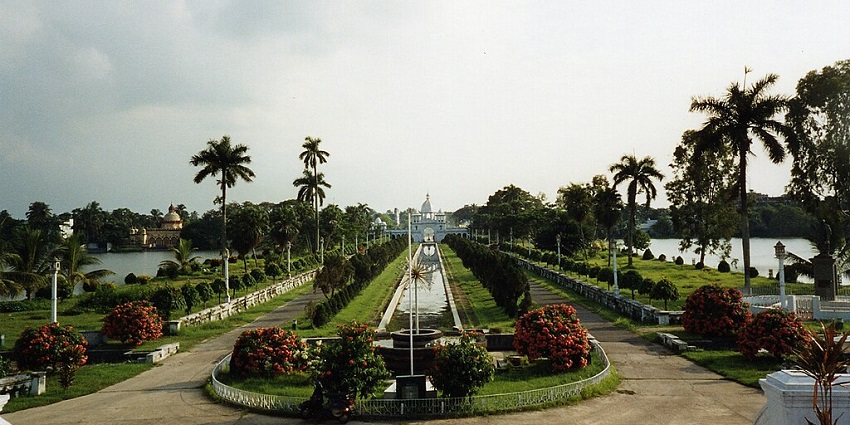 A breathtaking view of lush green gardens and palm trees of Tripura State Museum.