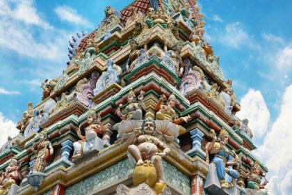 A breathtaking view of a temple from below with colourful architecture during the daytime.