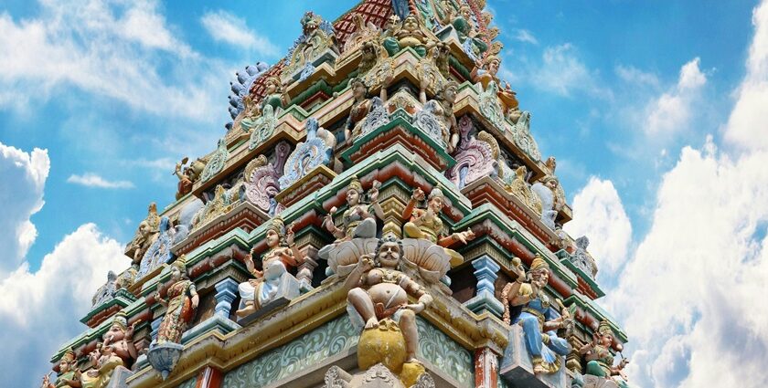 A breathtaking view of a temple from below with colourful architecture during the daytime.