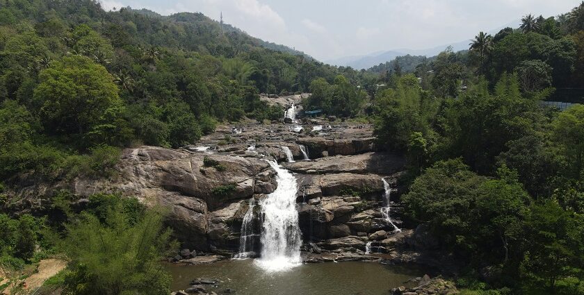 The stunning view of Palchuram Waterfalls, Kerala cascading down amidst lush greenery.