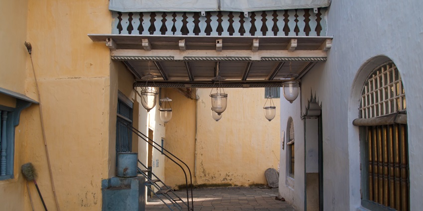 A yellow wall with big bulbs hung nearby