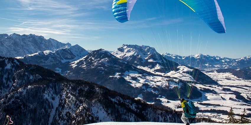 Paragliding allows you to soar through the skies and take in panoramic vistas of lush valleys.