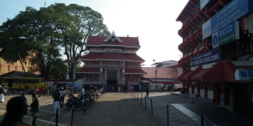 A picture of a temple taken from a distance showing the entrance and nearby street