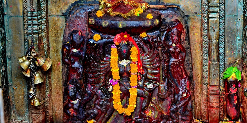 A picture of a statue of goddess Bhagvathy, decorated with garlands in a Kerala temple