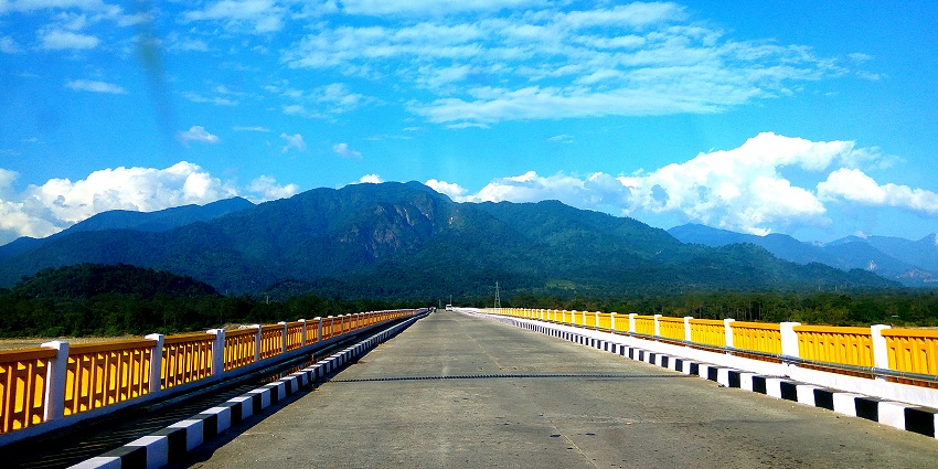 View of Pasighat Bridge spanning the Siang River, with scenic surrounding landscapes.