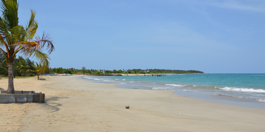 Pasikuda Beach with pristine white sand, clear turquoise water, and a tranquil coastal setting.
