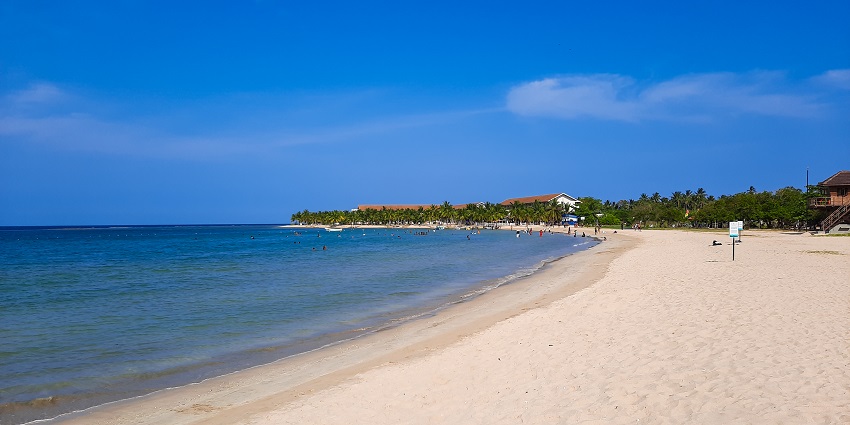 A glimpse of azure waters meeting the golden sands of Passikudah Beach in the region.