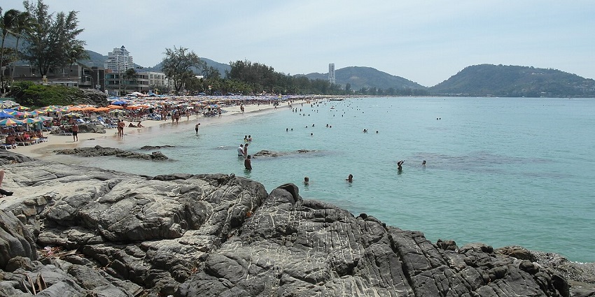 A scenic view of people having fun in turquoise waters at Patong Beach in Thailand