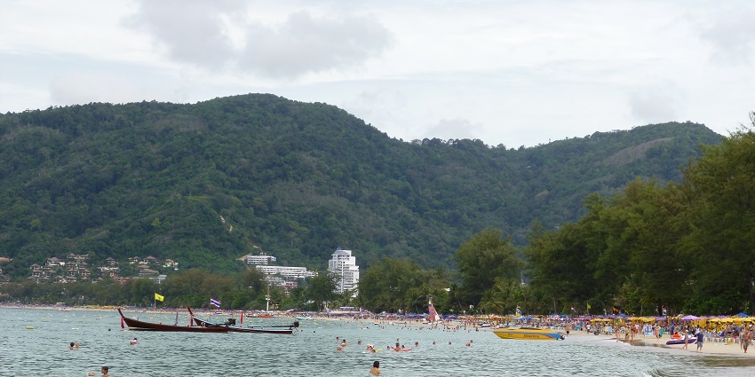 People having fun at the scenic Patong Beach, one of the famous beaches in Phuket.